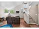 Bright living area with stairway to loft area, offering a comfortable seating arrangement and an outdoor view at 1777 Main St, Georgetown, CO 80444