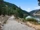 Scenic walking path near lake surrounded by mountains and trees at 1777 Main St, Georgetown, CO 80444