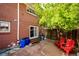 Charming brick home with a stone patio, mature tree, and space for outdoor activities and entertaining at 12632 W Virginia Ave, Lakewood, CO 80228