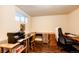 A basement office space with wood laminate flooring and built-in desk at 12632 W Virginia Ave, Lakewood, CO 80228