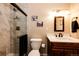 Elegant bathroom featuring a glass shower, modern vanity, and decorative wall art at 12632 W Virginia Ave, Lakewood, CO 80228