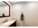 Elegant powder room with a granite vanity, stylish mirror, and contemporary fixtures at 12632 W Virginia Ave, Lakewood, CO 80228
