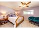 Bright bedroom featuring a ceiling fan, a comfortable bed, and a plush lounge chair at 12632 W Virginia Ave, Lakewood, CO 80228