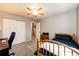 Bright bedroom showcasing a ceiling fan, carpeted floors, and access to closet and hallway at 12632 W Virginia Ave, Lakewood, CO 80228