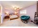 Spacious bedroom offering a large window, ceiling fan, and a plush, comfortable papasan chair at 12632 W Virginia Ave, Lakewood, CO 80228