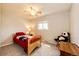 Comfortable bedroom with natural light, carpeted floor, ceiling fan, and warm neutral paint at 12632 W Virginia Ave, Lakewood, CO 80228