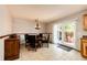 Well-lit dining area with sliding door to patio with outdoor seating area at 12632 W Virginia Ave, Lakewood, CO 80228