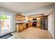 Bright kitchen with stainless appliances, wood cabinets, and sliding door to outdoor patio at 12632 W Virginia Ave, Lakewood, CO 80228