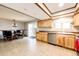 Open floor plan kitchen features stainless dishwasher and sink with view into dining area at 12632 W Virginia Ave, Lakewood, CO 80228