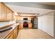 Well-lit kitchen featuring stainless steel appliances and light wood cabinets with tile floor at 12632 W Virginia Ave, Lakewood, CO 80228