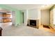Open-concept living area with a fireplace, seamlessly connecting to the kitchen and dining spaces at 12632 W Virginia Ave, Lakewood, CO 80228