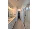 Modern bathroom with dual sinks, a large mirror, and a glass-enclosed shower at 6077 Caribou Dr, Brighton, CO 80601