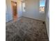 Cozy bedroom with neutral carpet and an attached bathroom featuring glass shower doors at 6077 Caribou Dr, Brighton, CO 80601