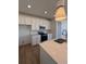 Well-lit kitchen with a quartz countertop, stainless steel appliances, and white cabinets at 6077 Caribou Dr, Brighton, CO 80601