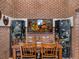 Dining room featuring exposed brick wall and eclectic decor, creating a modern yet rustic space at 6535 Brentwood St, Arvada, CO 80004