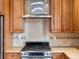 Close up of the kitchen with stainless steel range and mosaic tile backsplash at 6535 Brentwood St, Arvada, CO 80004