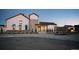 Modern farmhouse with inviting entrance and stone accents is beautifully landscaped at 7243 Prairie Sage Ln, Littleton, CO 80125