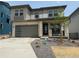 Charming two-story home with a stone facade, gray siding, well-manicured lawn, and attached two-car garage at 7243 Prairie Sage Ln, Littleton, CO 80125
