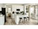 Modern kitchen with white cabinetry, stainless steel appliances, and an island with bar stools at 7243 Prairie Sage Ln, Littleton, CO 80125