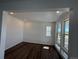 Bright living room with multiple windows, recessed lighting, white walls, and stylish hardwood floors at 7243 Prairie Sage Ln, Littleton, CO 80125