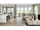 Spacious living room and dining room with lots of natural light and hardwood floors at 7243 Prairie Sage Ln, Littleton, CO 80125