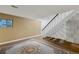 Finished basement area with stairs, decorative window, and neutral-toned carpet at 13993 E Jewell Ave, Aurora, CO 80012