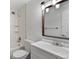 Clean bathroom with tile floors, a shower and tub, and a modern vanity at 13993 E Jewell Ave, Aurora, CO 80012