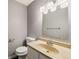 Functional bathroom with a vanity and well-lit mirror at 13993 E Jewell Ave, Aurora, CO 80012