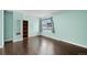 Bright bedroom with wood floors, built-in shelves, and a large window for natural light at 13993 E Jewell Ave, Aurora, CO 80012