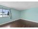 Bedroom featuring hardwood floors, neutral paint, and large window at 13993 E Jewell Ave, Aurora, CO 80012