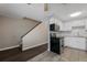 Bright kitchen featuring stainless steel appliances, white cabinets, and tiled backsplash at 13993 E Jewell Ave, Aurora, CO 80012
