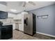 Traditional kitchen featuring white cabinetry, stainless steel appliances, and tile floors at 13993 E Jewell Ave, Aurora, CO 80012