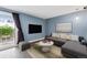 Stylish living room with sliding glass doors, modern furniture, and neutral color palette at 13993 E Jewell Ave, Aurora, CO 80012