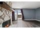Cozy living room with stone fireplace, sliding glass doors opening to the outdoor space at 13993 E Jewell Ave, Aurora, CO 80012