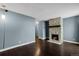 Spacious living room with hardwood floors, stone fireplace, and open floor plan at 13993 E Jewell Ave, Aurora, CO 80012