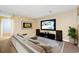 Cozy living room with a large TV, sectional sofa, and modern decor at 13993 E Jewell Ave, Aurora, CO 80012