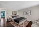 Comfortable bedroom with hardwood floors, stylish decor, and natural light at 13993 E Jewell Ave, Aurora, CO 80012