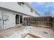 Back patio with a privacy fence and a small stone area, perfect for outdoor relaxation and gatherings at 13993 E Jewell Ave, Aurora, CO 80012