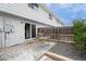 Cozy patio area with seating and sliding door access to the home, enhanced by a privacy fence and tasteful landscaping at 13993 E Jewell Ave, Aurora, CO 80012