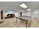 Finished basement with a ping pong table and a workstation featuring computers and shelves at 7439 S Depew St, Littleton, CO 80128
