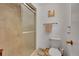 Neutral bathroom featuring a tiled shower with glass door, toilet, and towel rack at 7439 S Depew St, Littleton, CO 80128