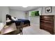 Comfortable bedroom with a window view, and a dark wood dresser at 7439 S Depew St, Littleton, CO 80128