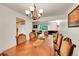 Bright dining room showcasing hardwood floors and a spacious layout leading into other living areas at 7439 S Depew St, Littleton, CO 80128
