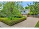 Two-story home featuring a manicured lawn, a mature shade tree, and a large driveway at 7439 S Depew St, Littleton, CO 80128