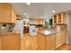 Well-lit kitchen boasts ample cabinet space, granite countertops, and hardwood floors at 7439 S Depew St, Littleton, CO 80128