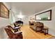 Spacious living room with hardwood floors, piano, and comfortable seating area at 7439 S Depew St, Littleton, CO 80128