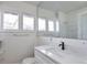 Bright bathroom features a modern vanity, speckled counter, and a large mirror at 2918 W 2Nd Ave, Denver, CO 80219