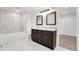 Beautiful bathroom with double vanity, soaking tub and elegant marble tiling at 2111 E Alameda Ave, Denver, CO 80209