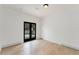 Light-filled room with access to an outdoor patio through black framed glass doors at 2111 E Alameda Ave, Denver, CO 80209