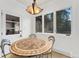 Cozy dining nook with custom table, lots of natural light from the large windows, and white trim at 2111 E Alameda Ave, Denver, CO 80209